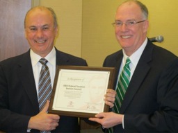 Leonard S. DeFranco (left) receives a plaque on behalf of the Section’s efforts to interact with tax authorities in Washington.
