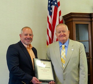 ISBA President-elect Hon. Russell W. Hartigan (right) presents a 2016 ISBA Law Enforcement Award to reitred Hinsdale Police Chief Bradley Bloom on July 22 at the Village Hall of Hinsdale.