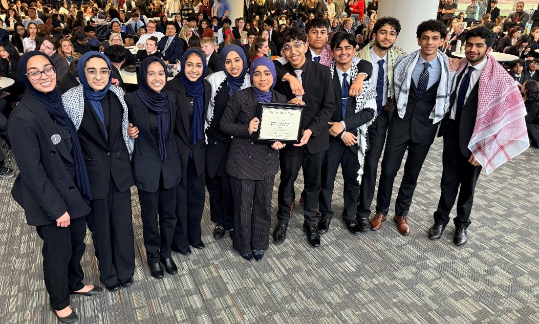 A photograph of the team from College Preparatory School of America with their award.