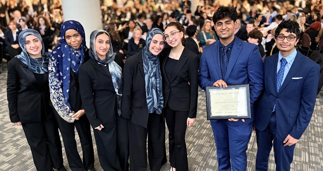 A photograph of the team from Kindi Academy with their award.