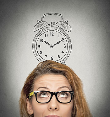 Woman looking up at a drawing of a clock