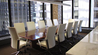 Corner Board Room with leather swivel chairs with a wall of windows overlooking downtown