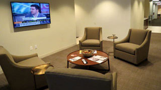 Lawyers Lounge with four large loung chairs and a TV