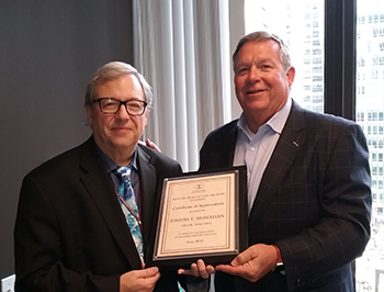 2017-18 Chair Robert J. Connor (left) presents a plaque to Joseph T. Monahan in recognition of his leadership of the ISBA Mental Health Section Council.