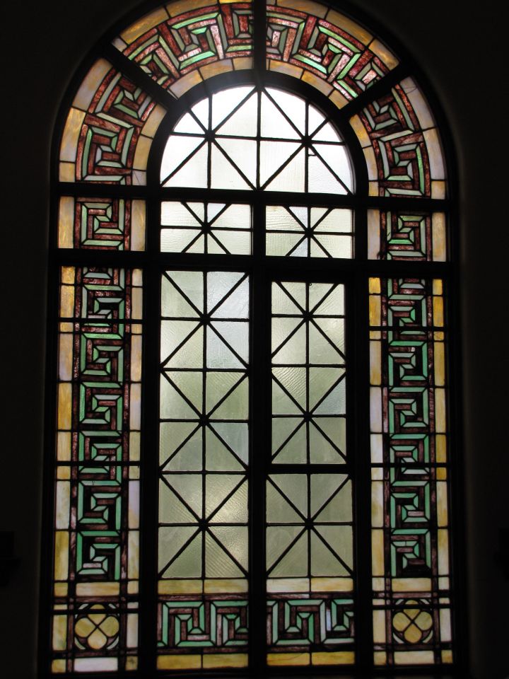 Stained-glass window behind judge's bench
