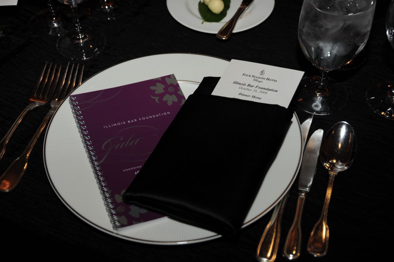 The program book and table setting reflected the black, white and purple color scheme.