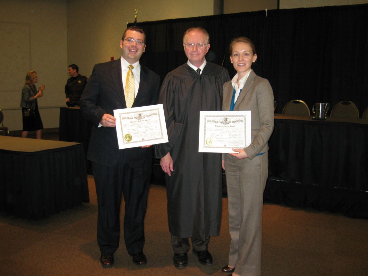 Husband and wife new admittees Michael Roush and Elizabeth Roush flank Justice Thomas L. Kilbride