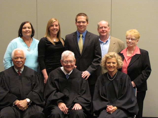 New admittee Connor Bidwill (rear, center) and his family with the justices.