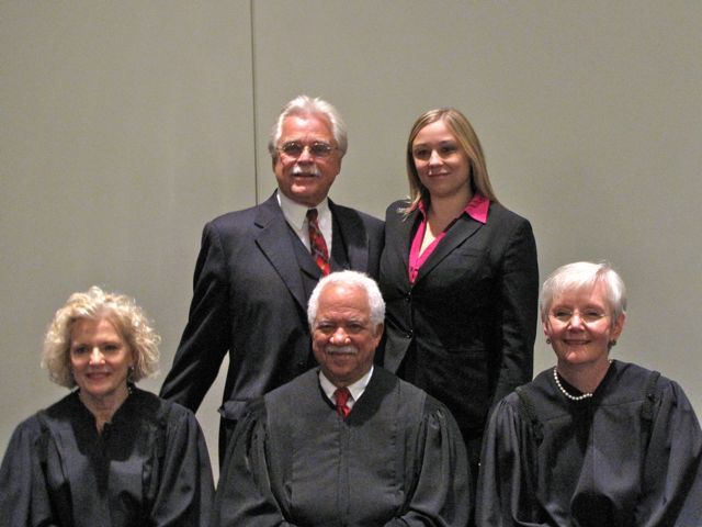 New admittee Jessica Kull with her father, Judge Geary Kull, with the justices.