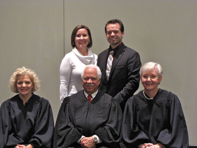 New admittee Conor LeFevour with a guest and the judges.