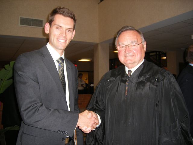 Justice Lloyd A. Karmeier congratulates new admittee Jason C. Dupont from Des Peres, Mo.