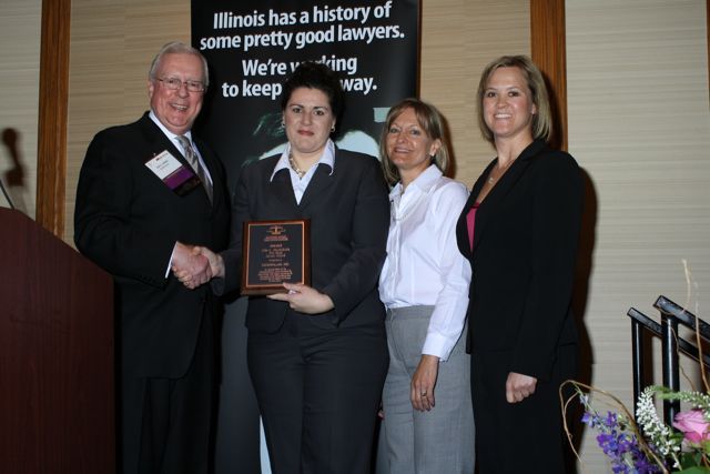 President O'Brien presents a John C. McAndrews Pro Bono Award to a team of lawyers from Caterpillar, Inc.