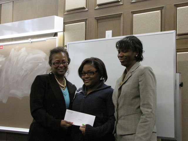 Buford and Perkins present the 1st place student writing award to Brianna Flowers of Frazier Prepatory.