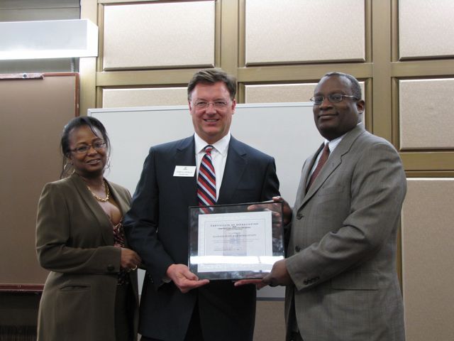 Cook County Bar Foundation President Angela Buford and Cook County Bar Association President Lawrence Hill present ISBA President-elect John Locallo with an award for the ISBA's support of the Cook County Law Day Luncheon.