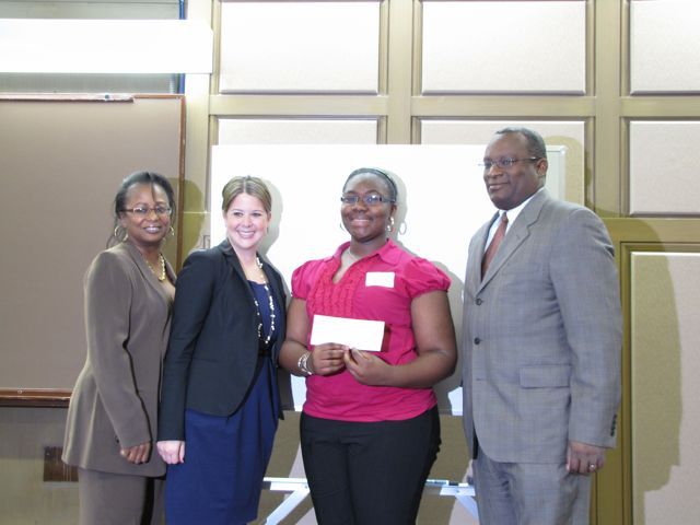 Angela Buford, Rebecca E. Cahan and Lawrence Hill present a $250 check to 1st place essay contest winner Taelar Chatman.