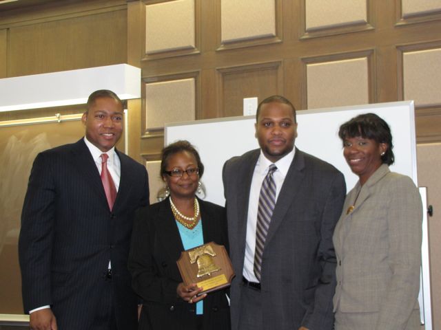 Buford and Perkins present an award to John Marshal Professor Sam Jones and John Marshall Black Law Students Association President Calvin Townsend.