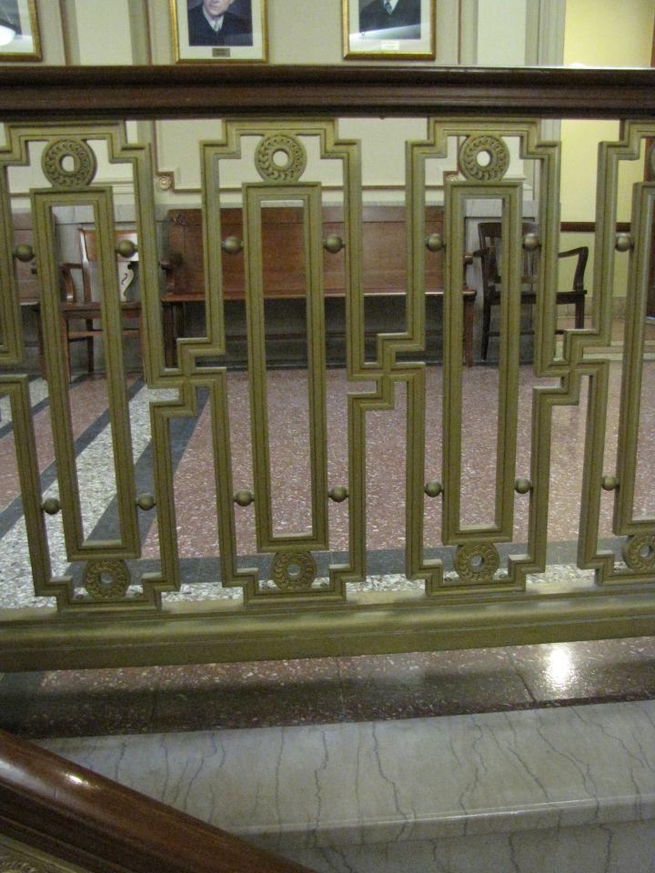 You have to look closely to notice the now-stigmatized shape in the bannister throughout the courthouse.