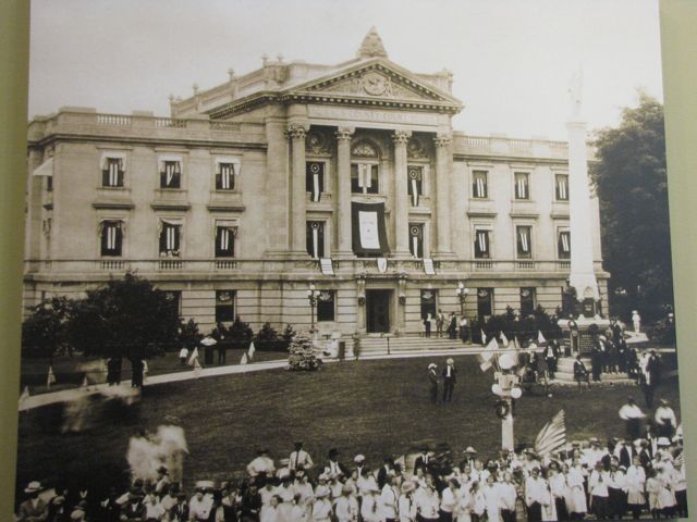 A celebration outside the courthouse following the end of World War I - notice the flags flying in each window.