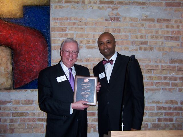 ISBA President John O'Brien receives a commemorative plaque from IBF President Vince Cornelius