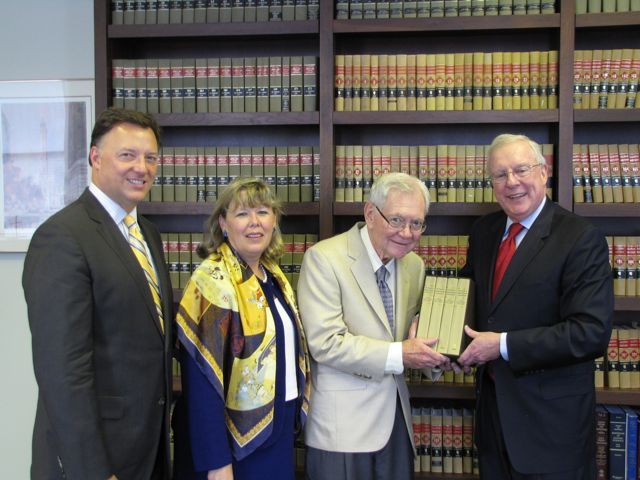 ISBA Immediate Past President John O'Brien presents "The Papers of Abraham Lincoln" to Chief Justice Thomas Fitzgerald as ISBA President-elect John Locallo (left) and ISBA 3rd Vice President Paula Holderman look on.