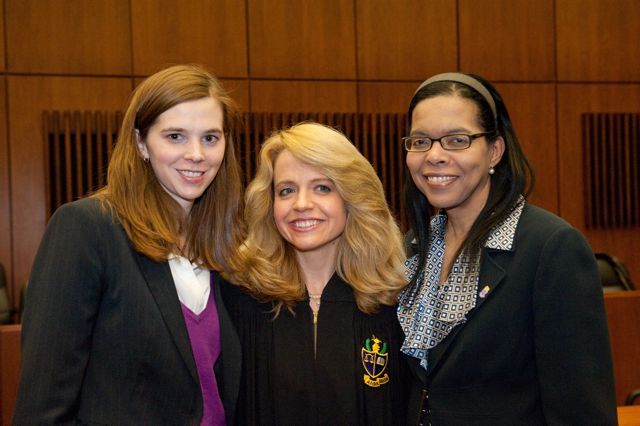 Chapter Justice Michele Jochner congratulates two new Phi Alpha Delta members and active ISBA members Laura Milnichuk (left) and Yolaine Dauphin.