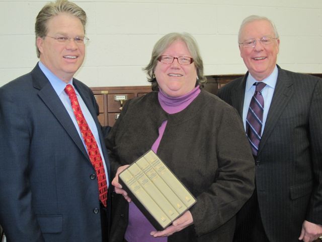President O'Brien (right) is joined by St. Clair County Bar Association President Charles Swartwout to present the four-volume set to Belleville Public Library director Harriett Zipfel.