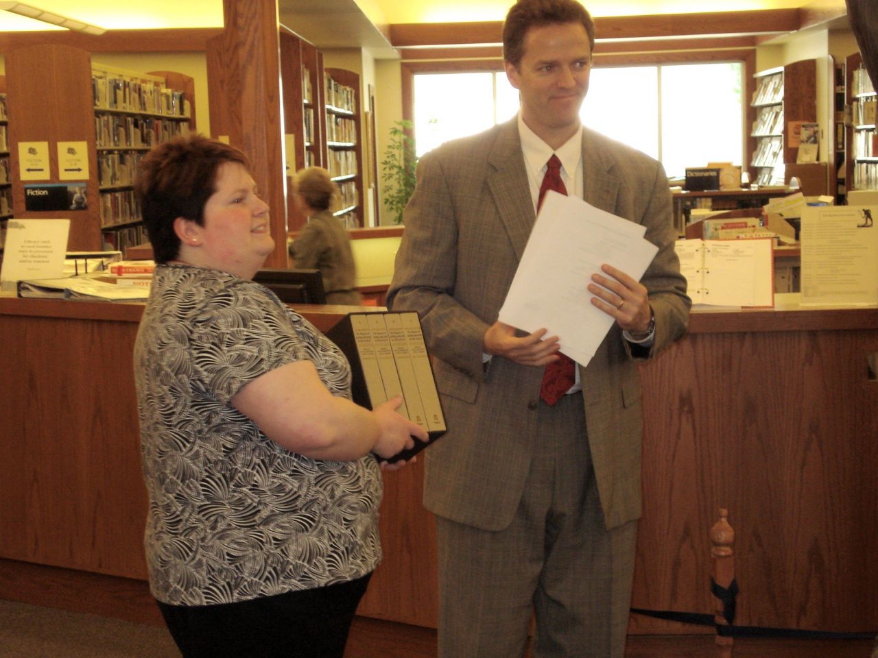 Illinois State Bar Association member Eric J. Dirnbeck, of Benton, presented a four-volume set of books, The Papers of Abraham Lincoln, to the Benton Public Library on April 13, as a gift from the ISBA and its charitable arm, the Illinois Bar Foundation. Accepting the books is Erin Steinsultz, library director. Also on hand for the presentation were (not pictured) attorneys Richard T. Lewis, David B. Garavalia, and Tracy L. Prosser, and Judge Loren P. Lewis, all of Benton.