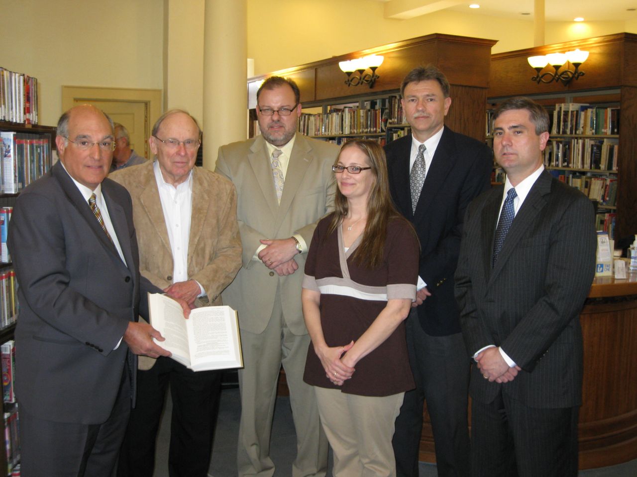 ISBA President-elect Mark Hassakis presented the Lincoln Papers book set to the Greenville Public Library on March 30. From left to right: Hassakis, with ISBA members Douglas Marti, Patrick Schaufelberger, Dora Mann, Judge John Knight and Chris Bauer at the historic Carnegie library in Greenville.