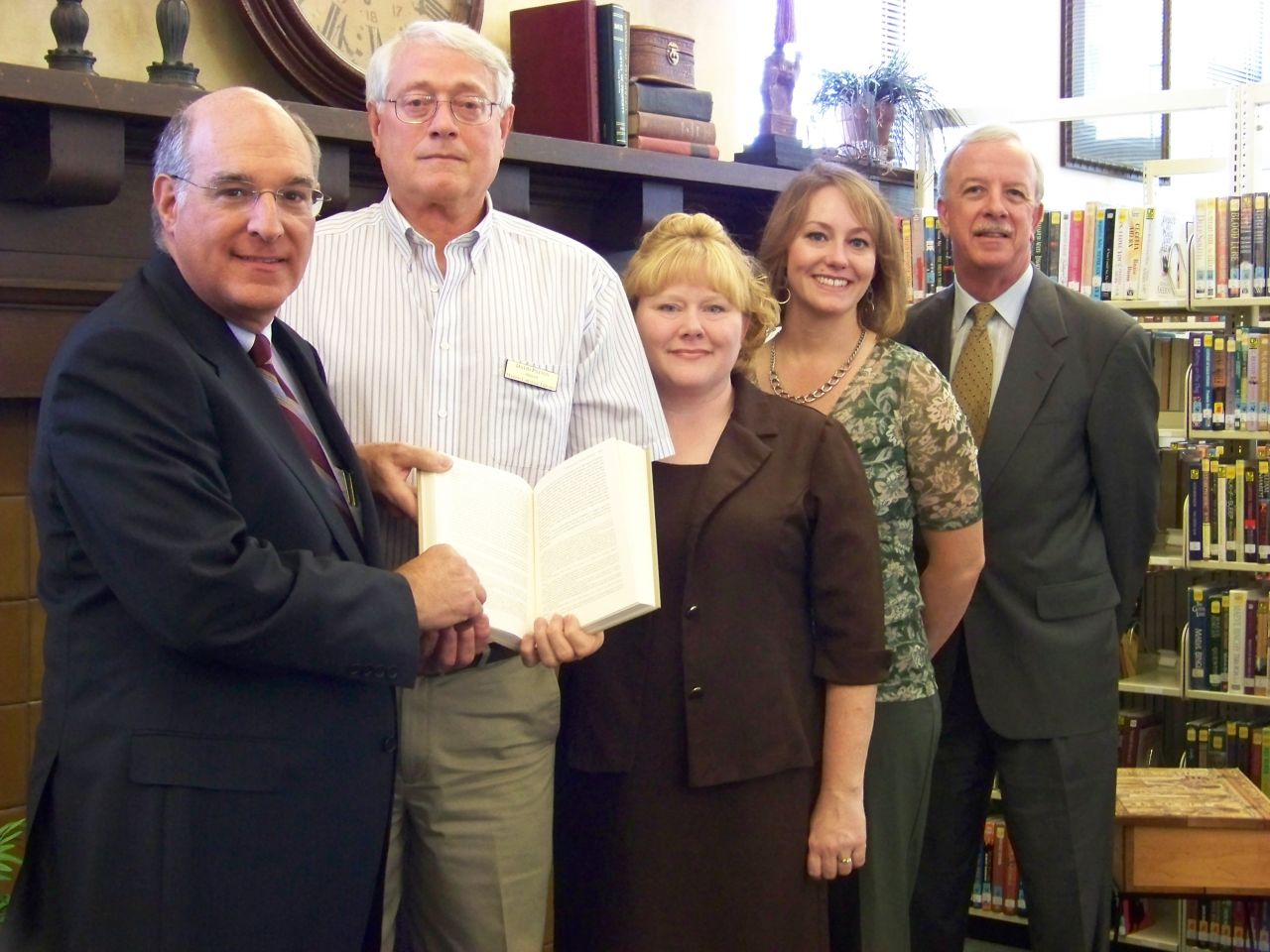 ISBA President-elect Mark D. Hassakis (left) presented The Papers of Abraham Lincoln to the Marion Carnegie Library in Marion on April 13. Accepting the books is library director David Patton (second from left). On hand for the presentation were (beginning 3rd from left) Tambra K. Cain, of the law firm Barrett, Twomey, Broom, Hughes & Hoke LLP, Jackson County Bar Association secretary; Amanda Byassee Gott, president, Williamson County Bar Association (WCBA); and William P. Novick of Marion, an ISBA and WCBA member. 