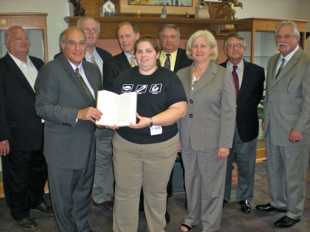 ISBA President-elect recently presented "The Papers" to the Mattoon library. On hand for the presentation were (front row: left to right): President-elect Hassakis, Director Ryan Franklin, Janet Grove; Back row (left to right): Stanton Dotson, John Barger, Greg Ray, Kent Heller, Steve Corn, Mark Ferguson