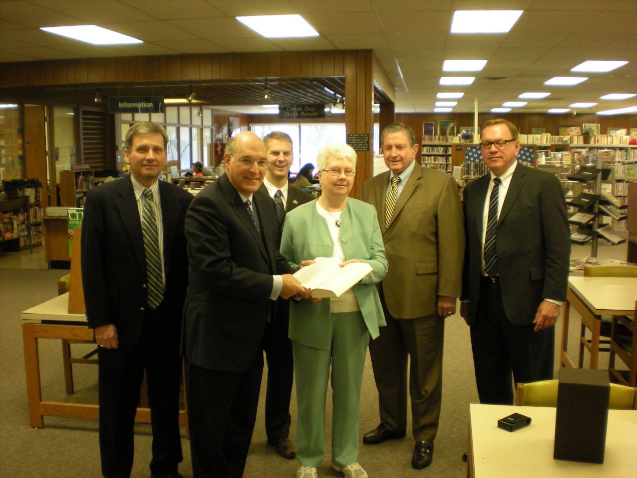 ISBA President-elect Mark Hassakis (second from left) presented the four-volume set to the Mt. Carmel Public Library on March 17 as a gift from the ISBA and its charitable arm, the Illinois Bar Foundation. Accepting the books is library director Louise Taylor.  On hand for the presentation were local attorneys (from left) John P. Farrar, William C. Hudson, George Woodcock Jr., and John E. Rhine.