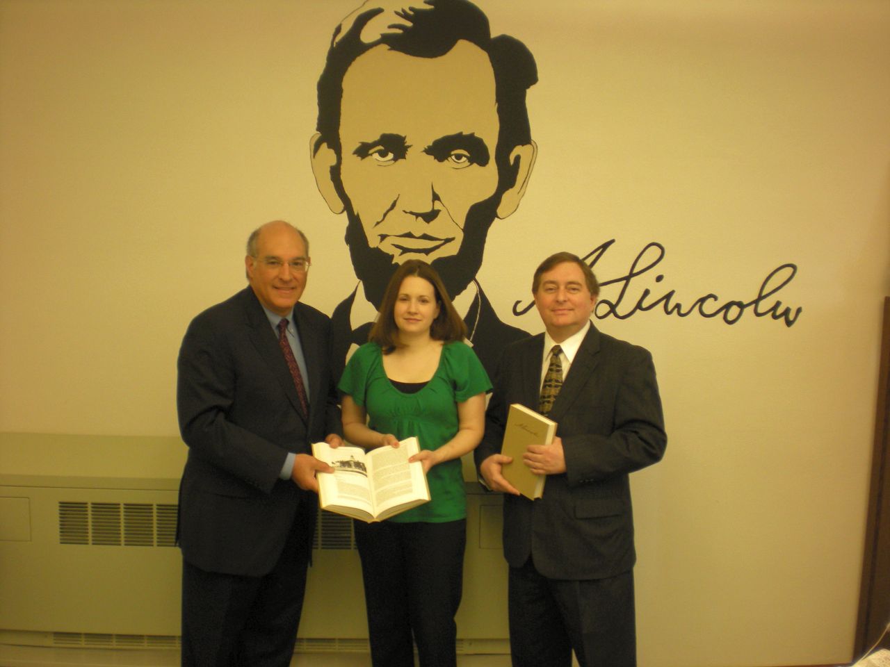 ISBA President-elect Mark Hassakis (at left) presented The Papers of Abraham Lincoln to the Vandalia Public Library on April 5. Accepting the books is Jessica Blain, library director. On hand for the presentation was Vandalia attorney David A. Oldfield, an ISBA member.