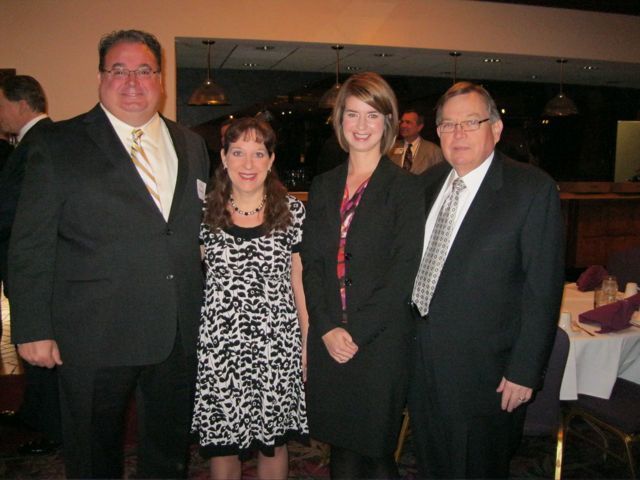   Kevin T. Hoerner, president of the St. Clair County Bar Association; Judge Julie Keehner Katz, chair of the organizing committee; Jamie Bracewell and Russell K. Scott, members of the ISBA Board of Governors. Scott is St. Clair Co. Bar Law Day Chair, and emcees the breakfast, attended by several hundred lawyers, judges, and community members.