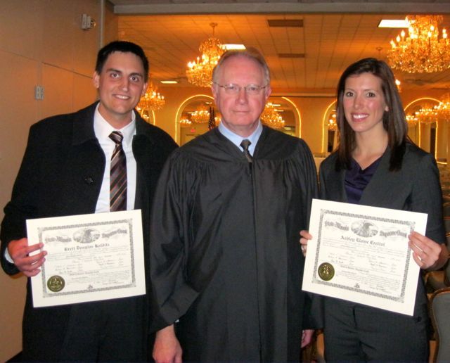 New admittee Brett Kolditz, Chief Justice Thomas L. Kilbride and new admittee Ashley Crettol