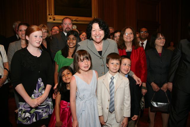 U.S. Supreme Court Justice Sonia Sotomayor poses with the children of the new admittees.
