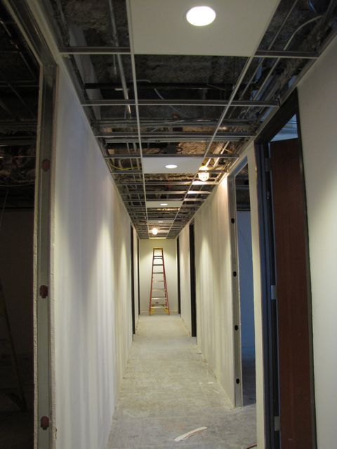 Lights and walls are up in the new hallway along the north side of the building.