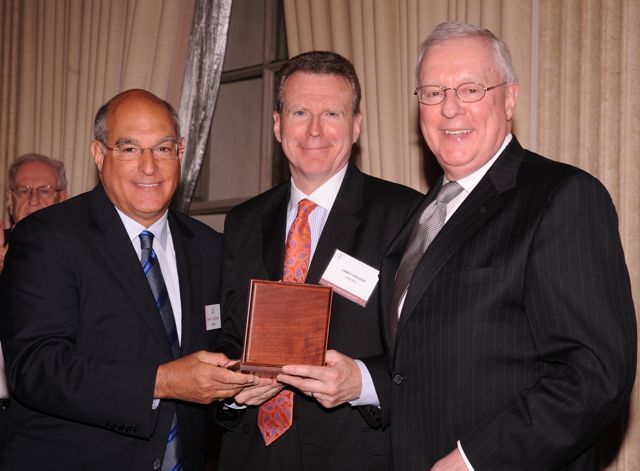 Deputy ARDC Administrator James J. Grogan receives a medal on behalf of Rosalyn B. Kaplan