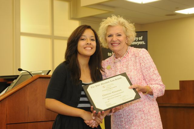 Cheyenne Quinones receives a Certificate of Completion from Justice Burke