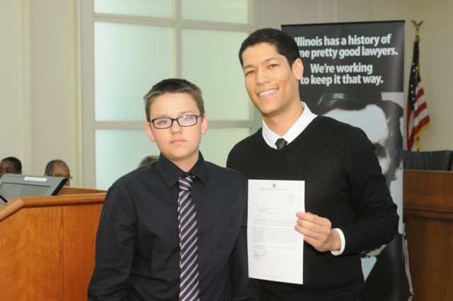 Thomas Roche Jr. receives the Achievement Award from teacher Phillip Rutherford