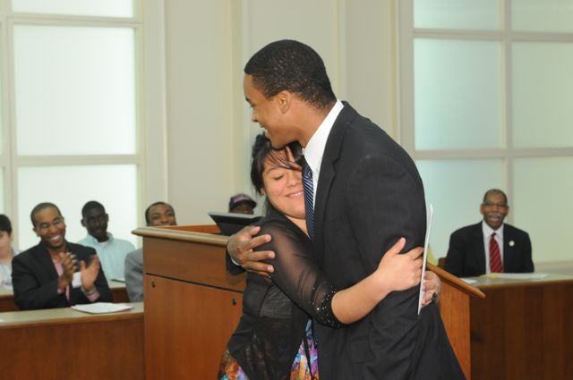 Teacher Terrance Garmon gets a hug from Lincoln Award winner Esperanza Gaytan