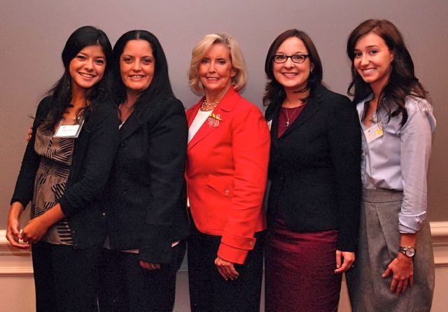 Noemy Garcia (far Left) and Emily Masalski (second from right) of the ISBA's Women and the Law Committee greet Lilly Ledbetter
