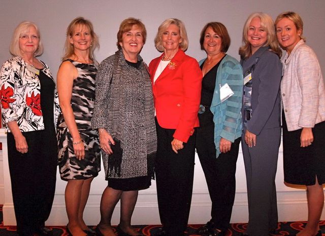 Sandra Crawford (second from right), immediate past Chair of the ISBA Women and the Law Committee, and friends greet Lilly Ledbetter.