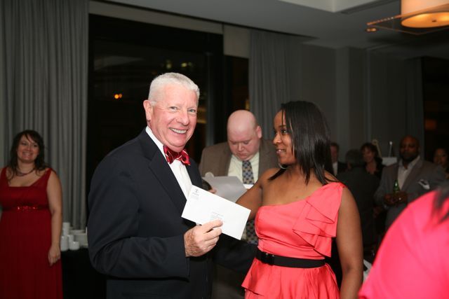 Kenya Jenkins-Wright presents David Sosin with White Sox tickets he won in the raffle.