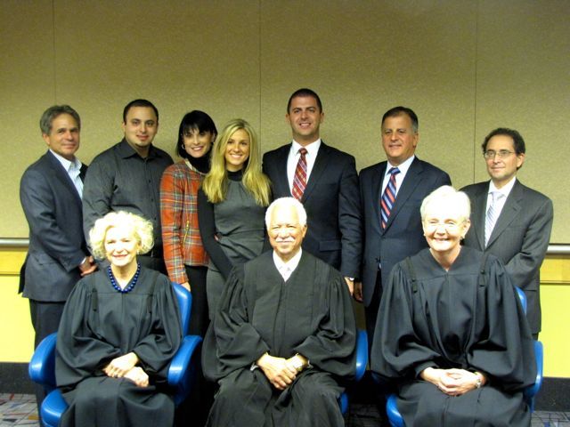 New admittee Jason Fisher and family with Justices Burke, Freeman and Theis