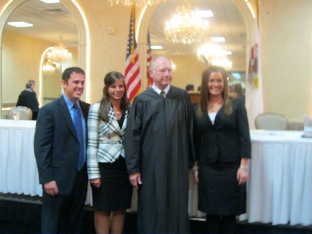 New admittees Arynn Wassel and Ryne Takacs, Chief Justice Thomas L. Kilbride and new admittee Allison VanNatta.
