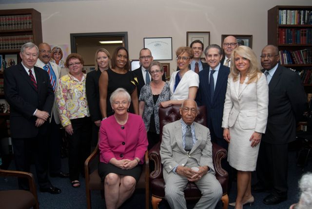 Judge Leighton is surrounded by members of the event Steering Committee.