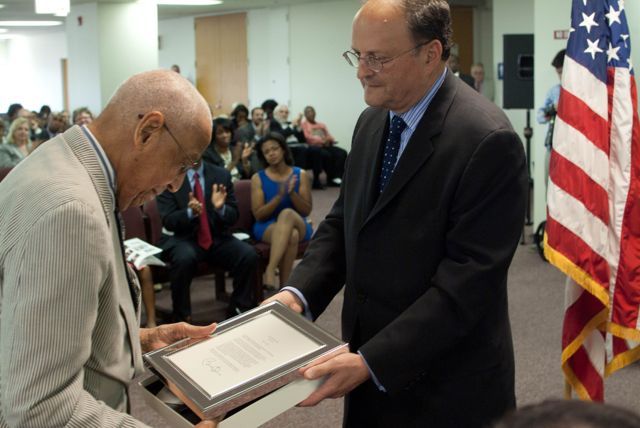 Jeffrey D. Colman, Partner at Jenner & Block and Vice-Chair of the event Steering Committee, presents Judge Leighton with a congratulatory letter from U.S. President Barack Obama.