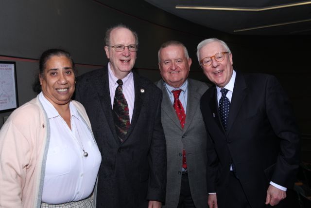 Prof. Cliff Scott-Rudnick of The John Marshall Law School is greeted by Chicago Alumni Chapter Board members Julie-April Montgomery, Hon. Russell Hartigan, and John O'Brien.
