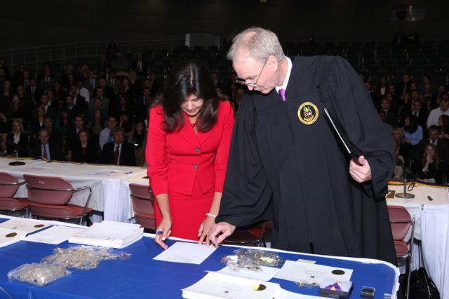 Cook County State's Attorney Anita Alvarez signs the membership role, as District XI Justice John K. Norris looks on.