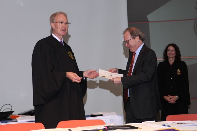 District XI Justice John K. Norris presents a membership certificate to DePaul University College of Law Dean Gregory Mark.